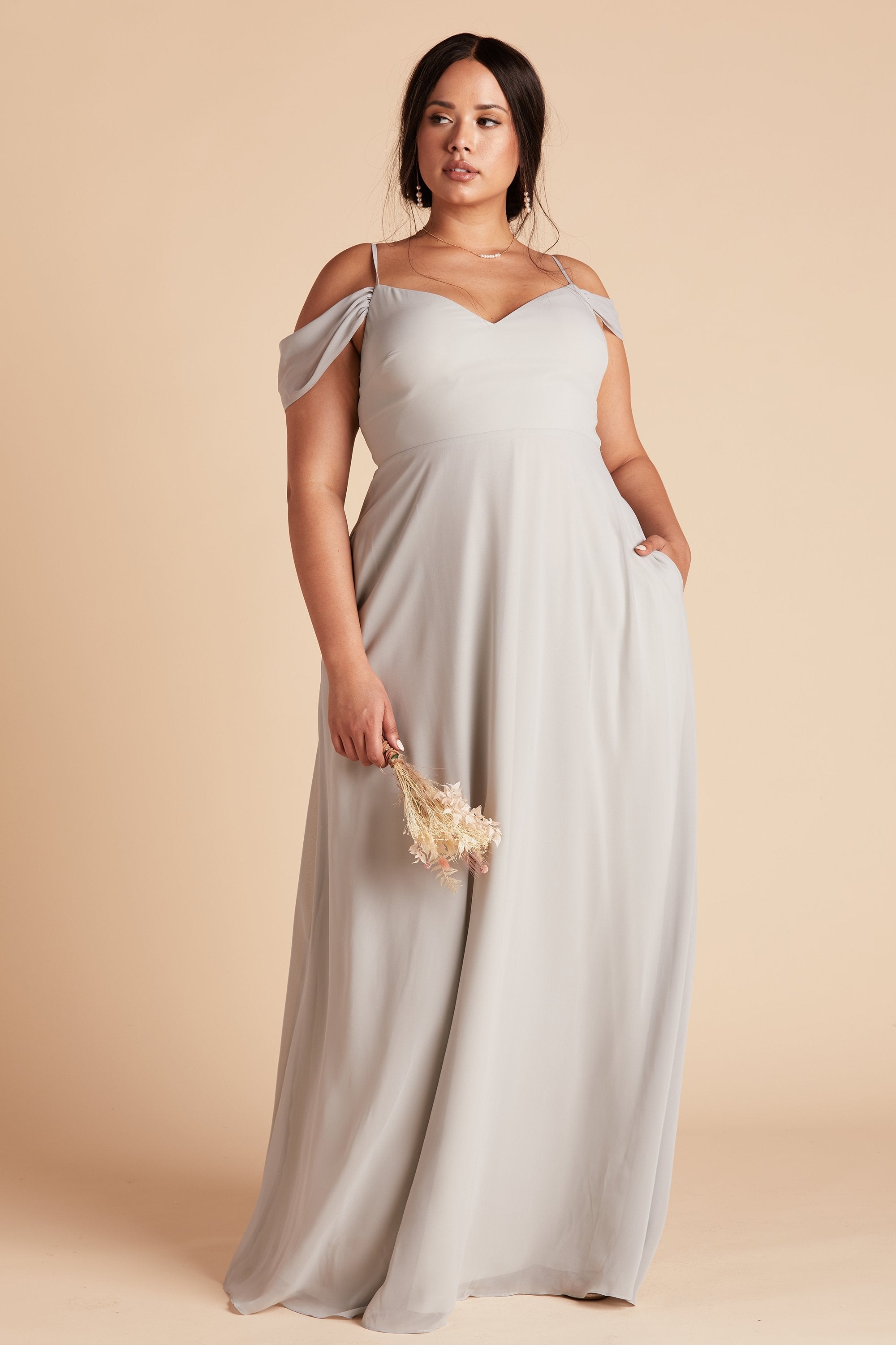 Devin convertible plus size bridesmaid dress in dove gray chiffon by Birdy Grey, front view with hand in pocket