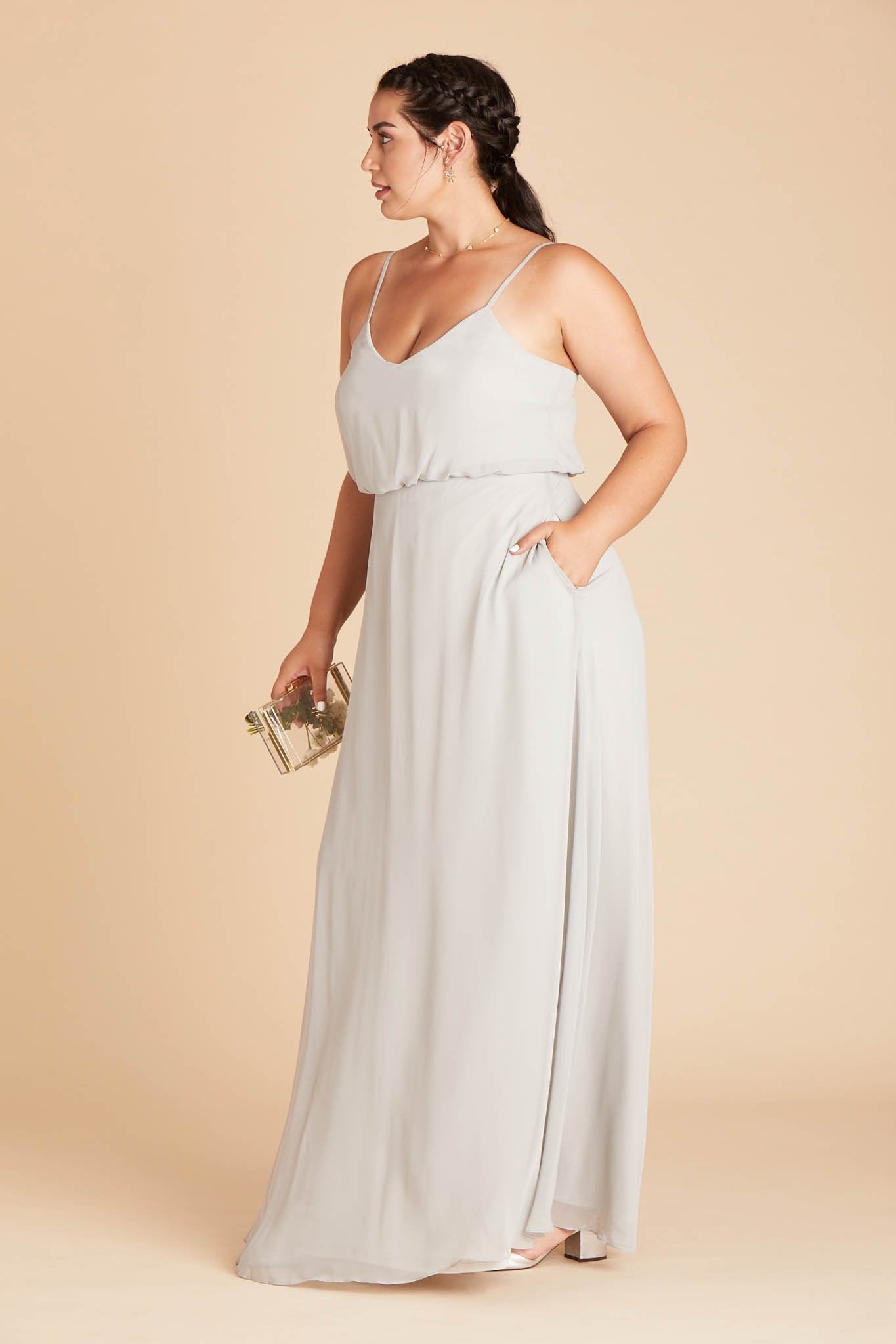 Gwennie plus size bridesmaid dress in dove gray chiffon by Birdy Grey, side view with hand in pocket