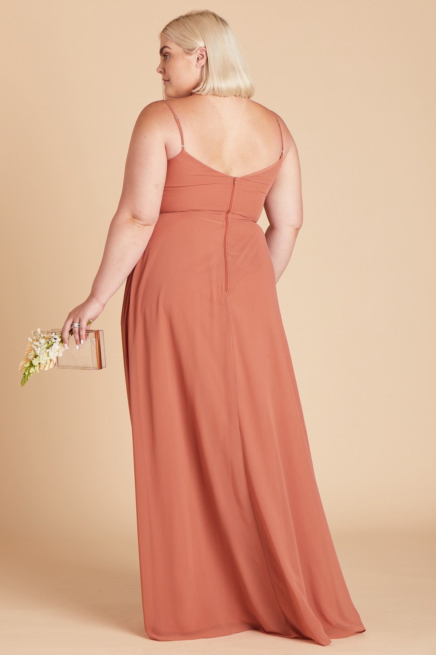 Back view of the floor-length Devin Convertible Plus Size Bridesmaid Dress in terracotta displays adjustable spaghetti straps and an open back with a slight v-cut just below the shoulder blades.