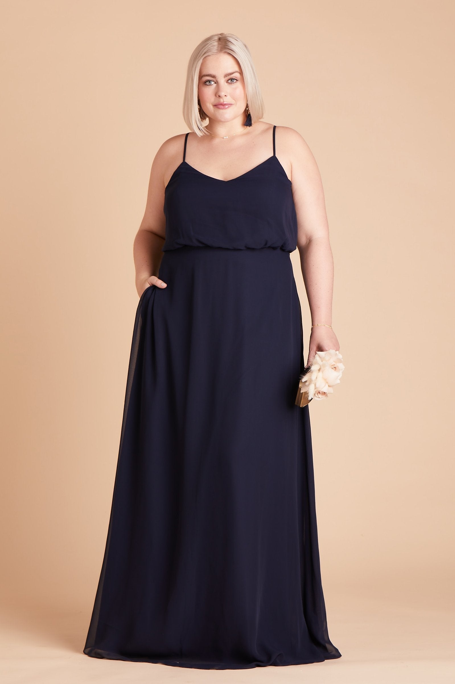 Gwennie plus size bridesmaid dress in navy blue chiffon by Birdy Grey, front view with hand in pocket