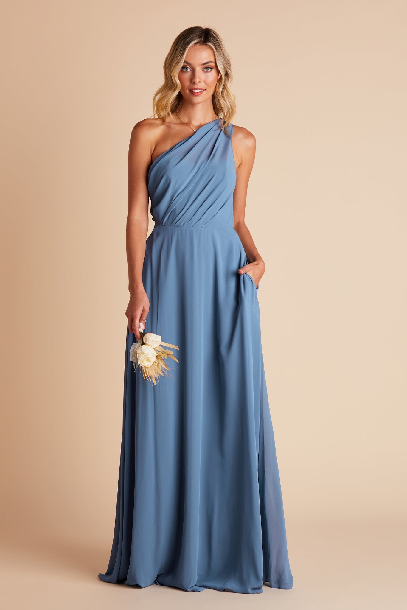 Kira bridesmaids dress in twilight blue chiffon by Birdy Grey, front view with hand in pocket