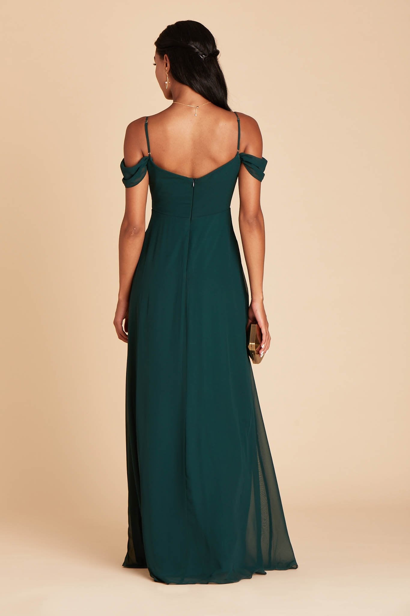 Back view of the floor-length Devin Convertible Bridesmaid Dress in emerald chiffon displays adjustable spaghetti straps and an open back with a slight v-cut just below the shoulder blades.